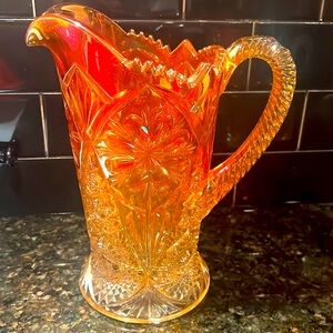 Vintage orange crystal pitcher, has a tiny chip in the base